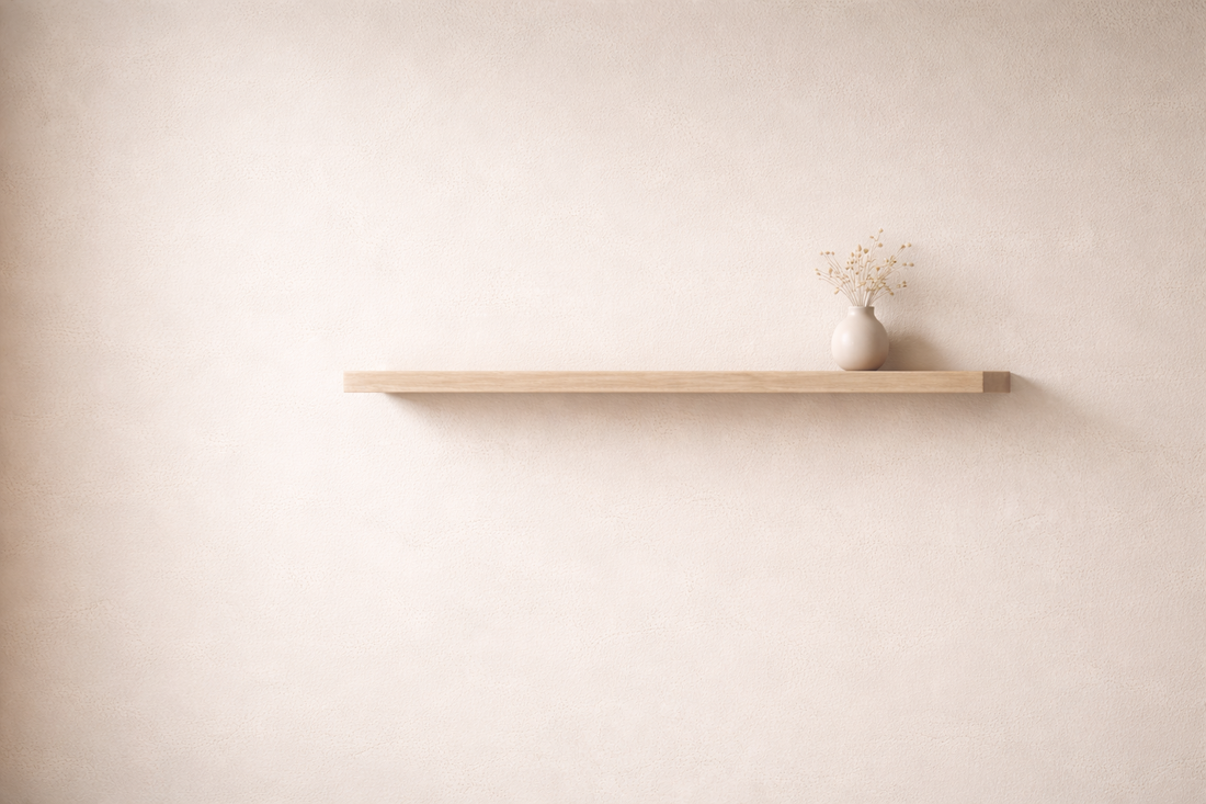 Seamless floating shelf blending into a neutral wall.