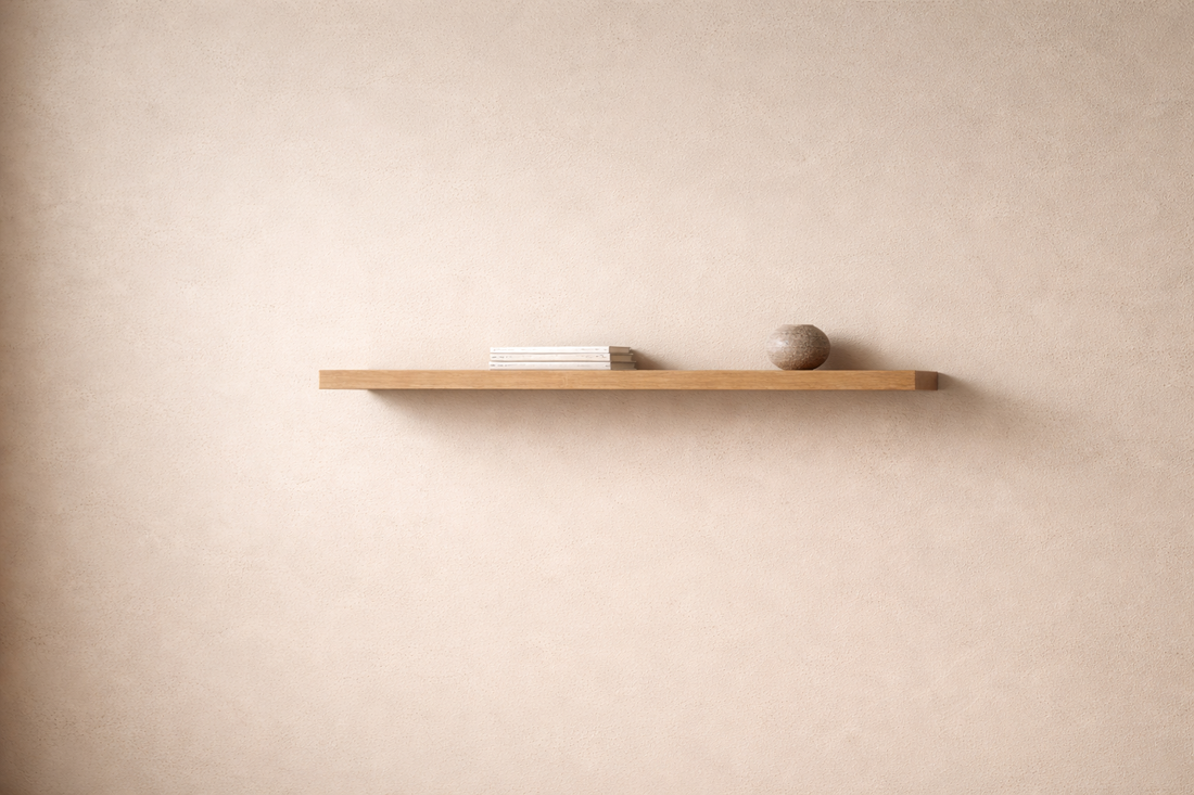 Floating shelf with minimal objects balancing an empty wall.